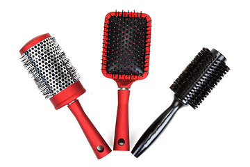 Image showing Three red massages comb on white background