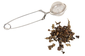 Image showing Dry green tea and strainer