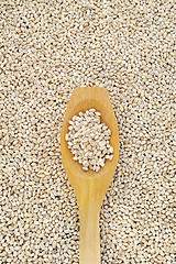 Image showing Wooden spoon and dried pearled barley
