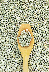 Image showing Wooden spoon and dried green split peas