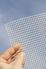 Image showing Detail of glass-fiber mesh in hand – reinforcing material for insulation