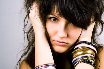 Image showing young brunette lady with bracelets