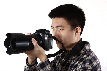 Image showing Young male photographer at studio, isolated on white 