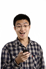 Image showing casual man smiling feel surprised on a mobile phone isolated ove