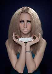 Image showing woman meditating holding the big white flower