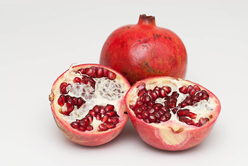 Image showing fresh cut pomegranate on a white background