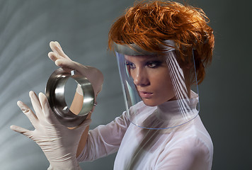 Image showing Futuristic woman examine metal detail