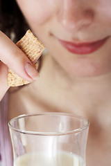 Image showing Young people eating milk with cereals