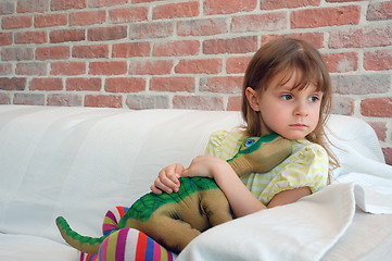 Image showing child with a toy dinosaur