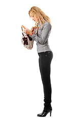 Image showing Young blonde looks in her handbag