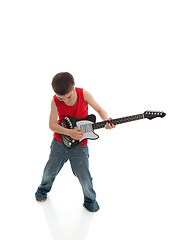 Image showing Little boy playing a guitar