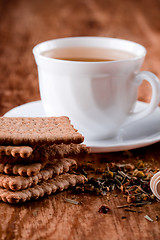 Image showing cup of fresh herbal tea and some cookies 