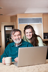 Image showing Teenage girl with grandpa using laptop