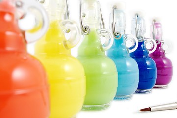 Image showing Colorful flasks and brush
