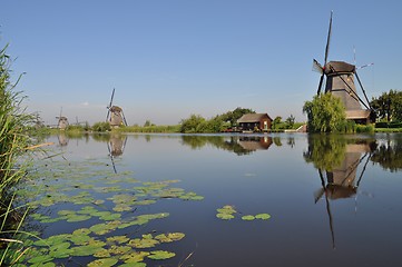 Image showing Dutch mill reflecting in a canal