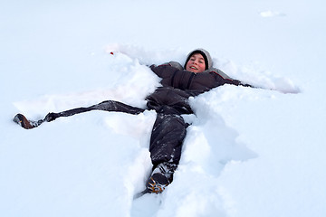 Image showing Happy Boy Laying In Fresh Snow