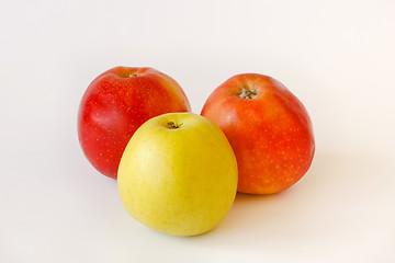 Image showing two red and one green apples on white background