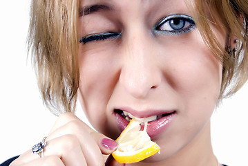 Image showing girl eating a lemon  