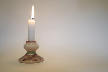 Image showing A simple candle lit with space for a message