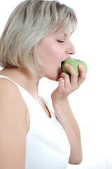 Image showing young woman biting an apple