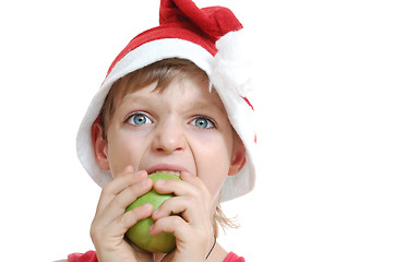 Image showing Christmas boy biting an apple