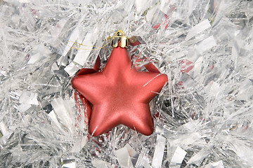 Image showing red star, christmas decoration on silver tinsel