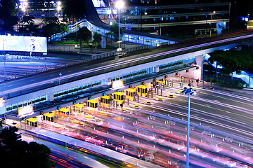 Image showing blurred bus light trails in downtown night-scape 