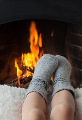 Image showing Children's feet are heated in the fireplace