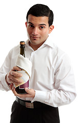 Image showing Waiter or servant holding bottle of wine