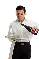 Image showing Waiter or bartender pouring wine