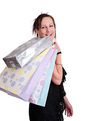 Image showing young woman with shopping bags on white