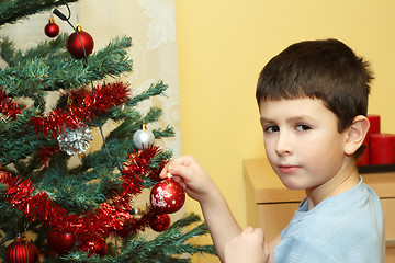 Image showing Young boy holding Christmas decorations