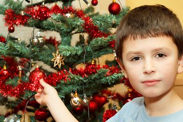 Image showing Young boy holding Christmas decorations