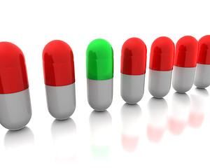 Image showing Green pill among reds 