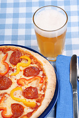 Image showing Hot spicy pizza and beer