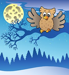 Image showing Cute flying owl in snowy landscape