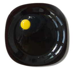 Image showing raw egg on a black plate