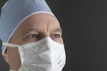 Image showing Portrait shot of a male physician in a hat and mask, reflecting confidence, strength, and expertise. Model released. (14MP camera)