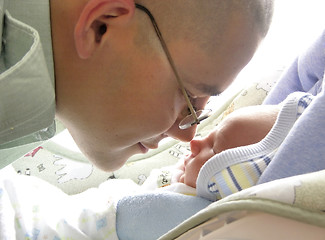 Image showing A father soldier meets his newborn son for the first time at 5 days of life.