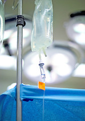 Image showing An IV (intravenous) bag containing life sustaining fluid hangs on a pole in the operating room. (14MP camera)