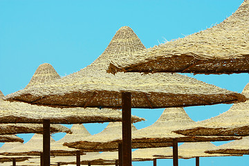 Image showing Umbrellas on blue sky background