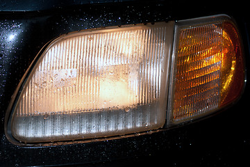 Image showing headlight by rain with water splash