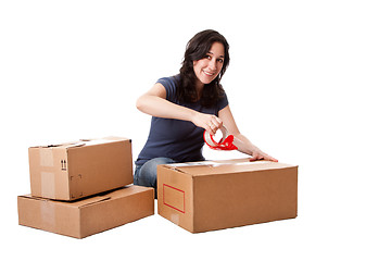 Image showing Woman taping moving storage boxes