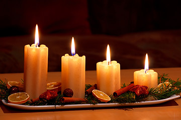 Image showing Christmas decorated table with lighting candles