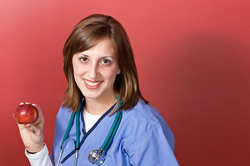 Image showing Nurse Holds An Apple