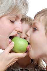 Image showing people biting apple