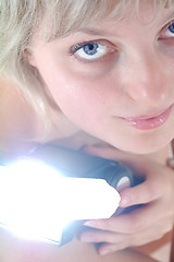 Image showing beautiful blond woman with a flash