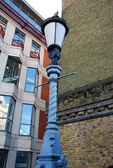 Image showing Streetlamp between office building and brick wall