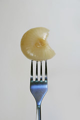 Image showing A pickled onion with a bite out of it