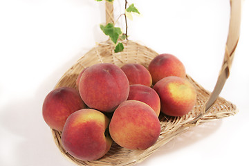 Image showing A basket of delicious, succulent peaches